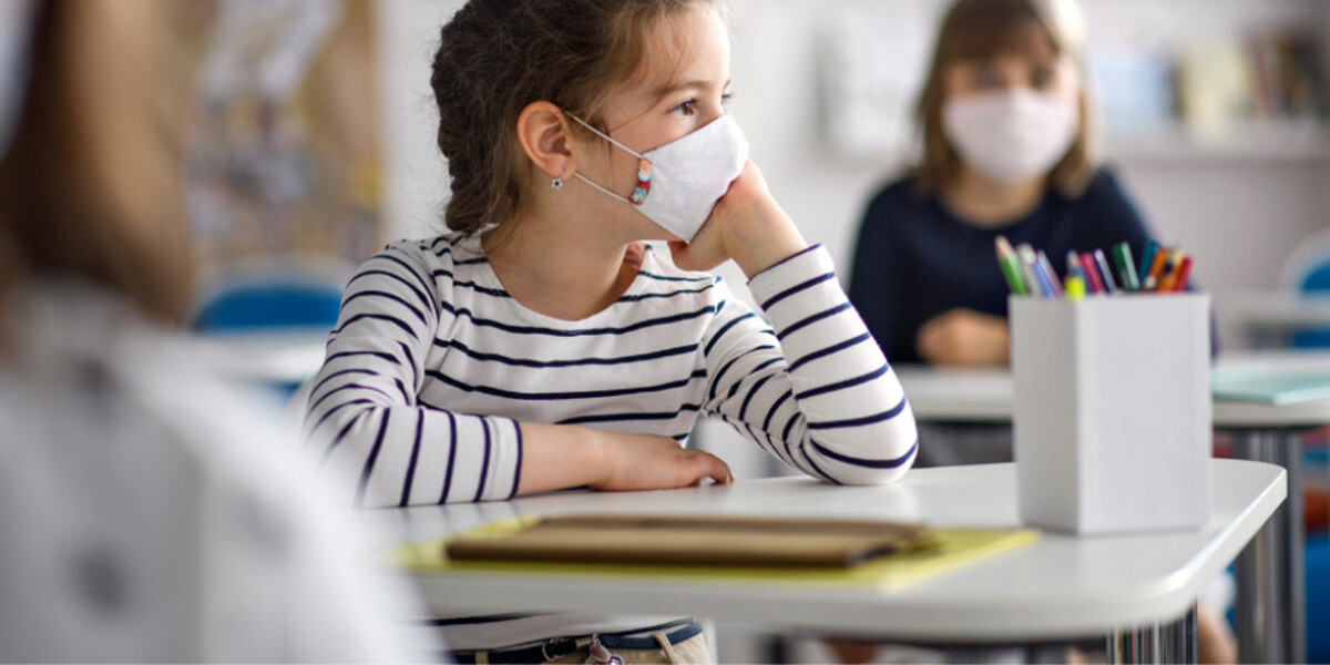 Young students wearing face masks and social distancing during the pandemic